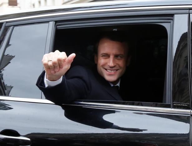 Emmanuel Macron, head of the political movement En Marche !, or Onwards !, and candidate for the 2017 presidential election, waves from his car as he leaves his home during the second round of the election, in Paris