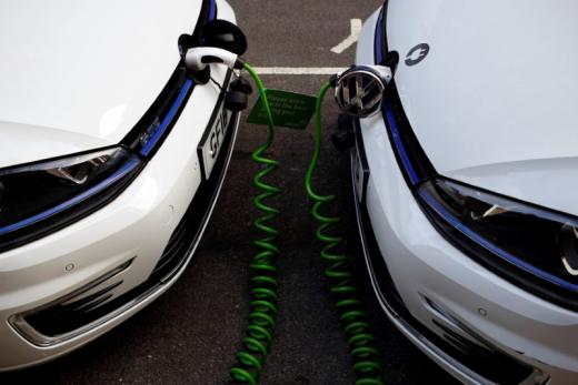 FILE PHOTO: Electric Volkswagen cars are plugged into a recharging point in central London