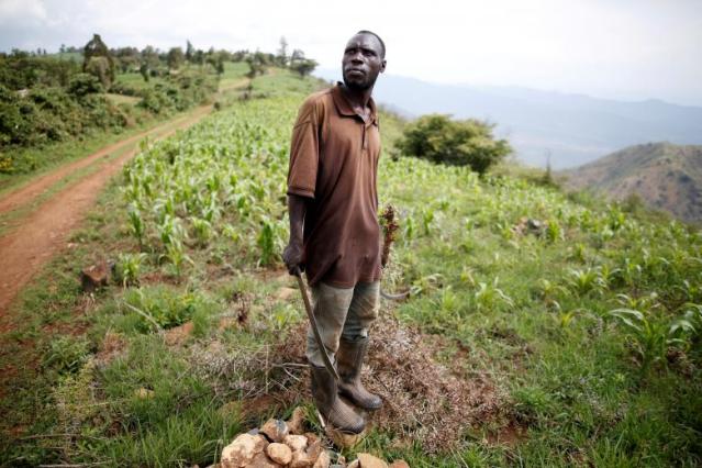 Kenyan Farmer Gerald Maina, holds a machete as he patrols the edge of the Rift Valley after a spate of attacks in Kamweje village in Laikipia County, Kenya