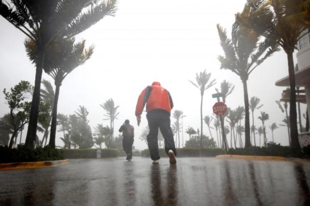 People walk along a street in South Beach as Hurricane Irma arrives at south Florida, in Miami Beach