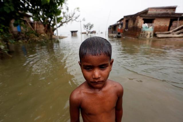 Boy is pictured in a flooded village in Motihari