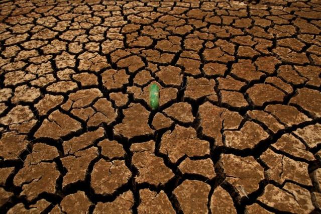 A bottle is seen on a parched ground at Guadalteba reservoir during a strong drought in Ardales