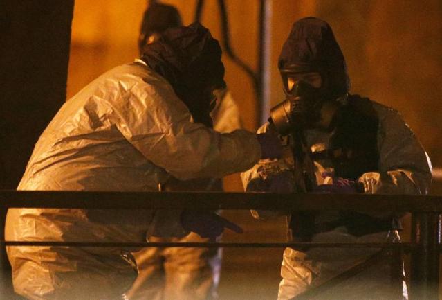 Members of the emergency services wearing protective clothing work near the bench where former Russian intelligence officer Sergei Skripal and his daughter Yulia were found poisoned in Salisbury
