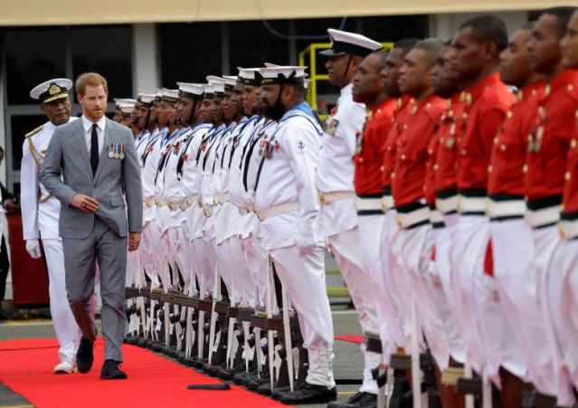 Britain's Prince Harry inspects a guard of honour on his arrival in Suva