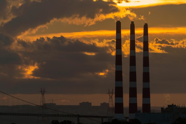 Smoke stacks from a coal fired power plant at dusk.