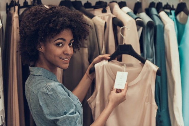 Smiling Young Woman Shopping In Clothing Store. Happy Beautiful