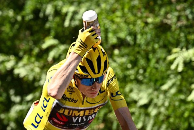 Jumbo-Visma team's Danish cycling star Jonas Vingegaard cools down with water during a stage in the 2022 edition of the Tour de France.