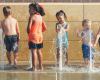A group of children is cooling themselves down during a heatwave.