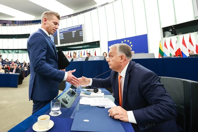 Péter Agyar and Viktor Orbán pictured in 2024 shaking hands in the EU Parliament.