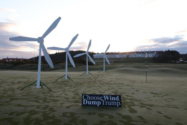 Greenpeace activists install a wind farm on a green of the Trump Turnberry Golf Club, together with a sign reading ‘Choose wind, dump Trump’.